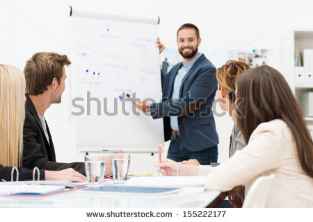 stock-photo-businessman-giving-a-presentation-to-his-colleagues-at-work-standing-in-front-of-a-flipchart-with-155222177